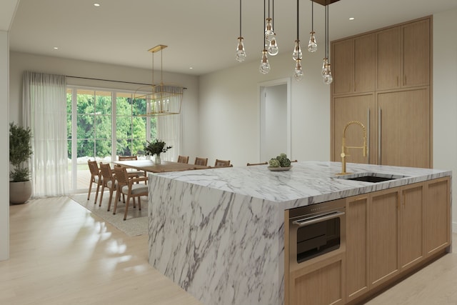 841 Quarry, Rochester Hills, MI 48306 - kitchen featuring pendant lighting, an island with sink, a sink, light wood finished floors, and light stone countertops