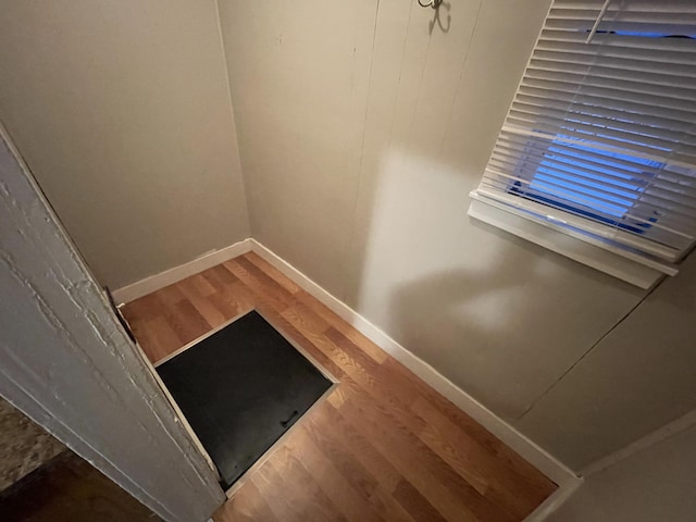 staircase with hardwood / wood-style floors