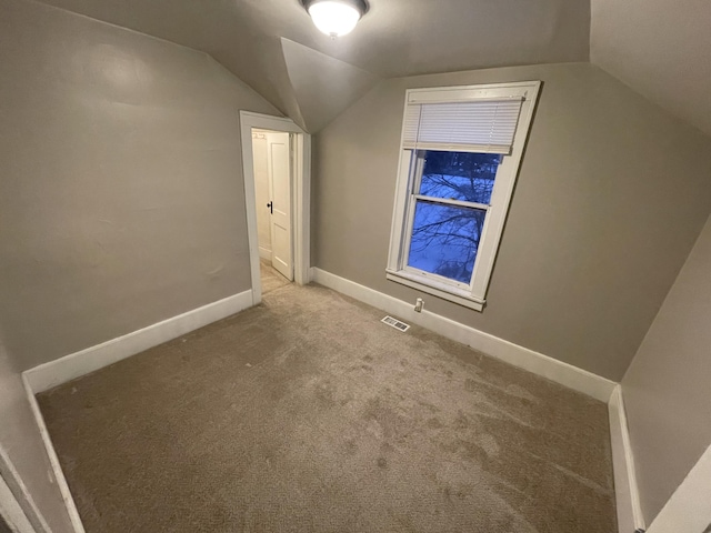 bonus room featuring lofted ceiling and carpet flooring