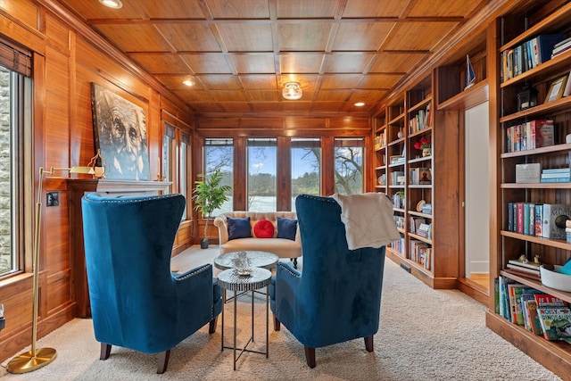 sitting room with built in shelves, a wealth of natural light, carpet, and wood ceiling