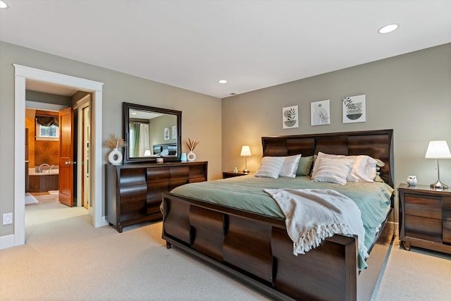 carpeted bedroom featuring connected bathroom