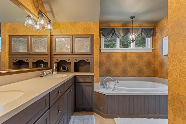 bathroom featuring a washtub, vanity, and tile patterned flooring