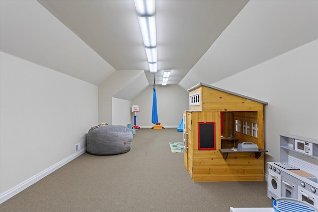 recreation room with carpet and vaulted ceiling