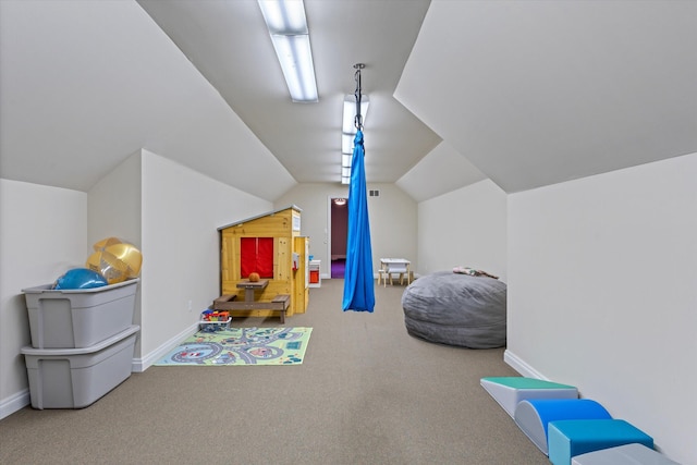 playroom featuring carpet floors and vaulted ceiling