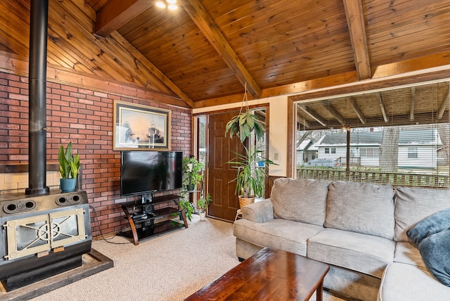 carpeted living room featuring wooden ceiling, a wood stove, brick wall, and beam ceiling