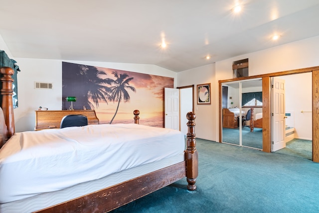 bedroom featuring vaulted ceiling, a closet, carpet floors, and ensuite bath