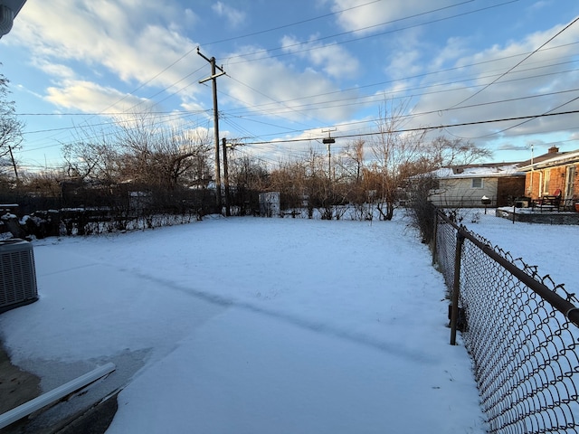 yard covered in snow featuring central AC