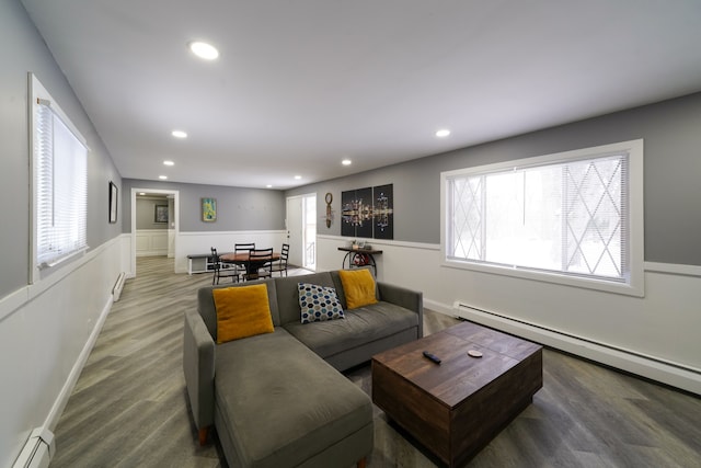 living room with hardwood / wood-style floors and a baseboard heating unit