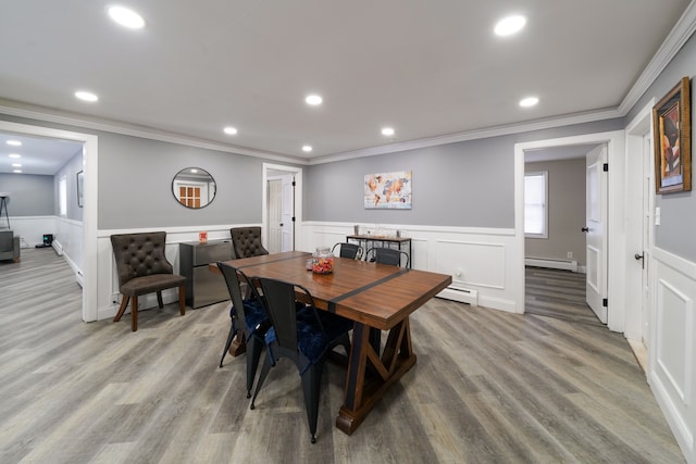 dining area featuring baseboard heating, light hardwood / wood-style floors, and ornamental molding