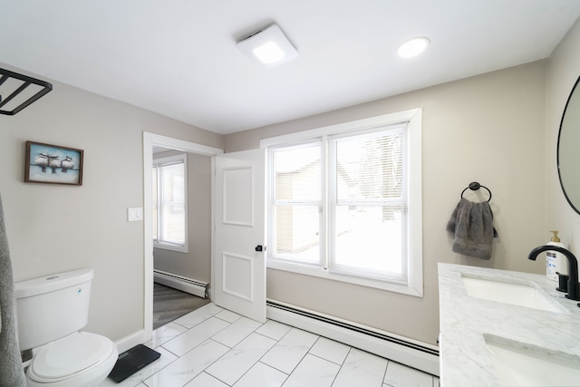 bathroom with a baseboard heating unit and a wealth of natural light