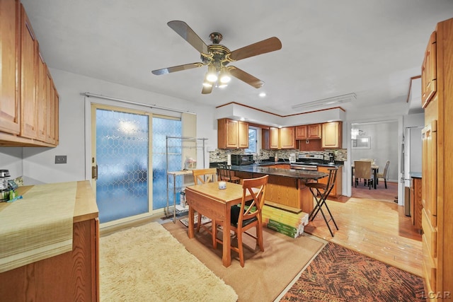 dining space featuring ceiling fan and light hardwood / wood-style floors