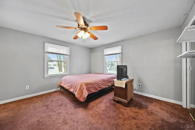 carpeted bedroom featuring a textured ceiling and ceiling fan