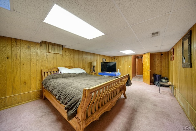 bedroom with carpet and wood walls