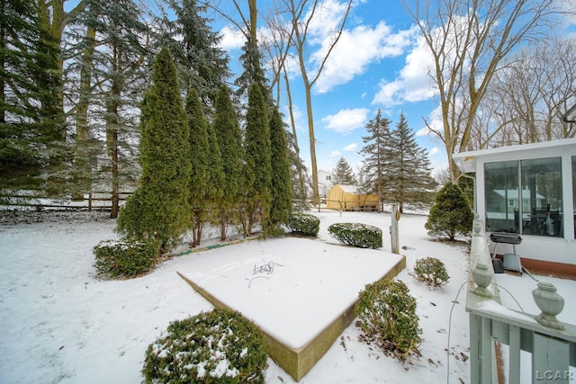 view of yard layered in snow