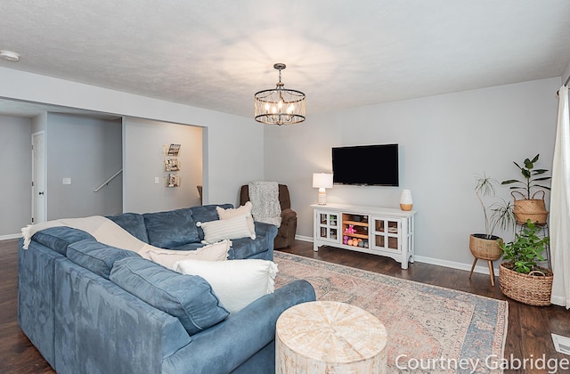 living room featuring dark hardwood / wood-style flooring and a notable chandelier