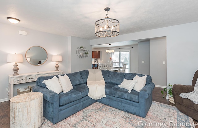 living room with light wood-type flooring and a notable chandelier