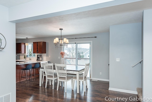 dining room featuring a notable chandelier and dark hardwood / wood-style flooring