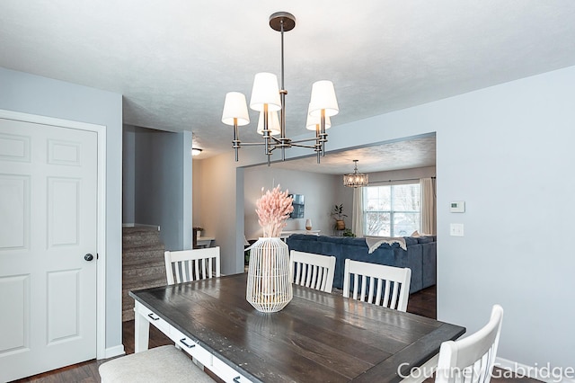 dining area featuring dark hardwood / wood-style floors and a notable chandelier