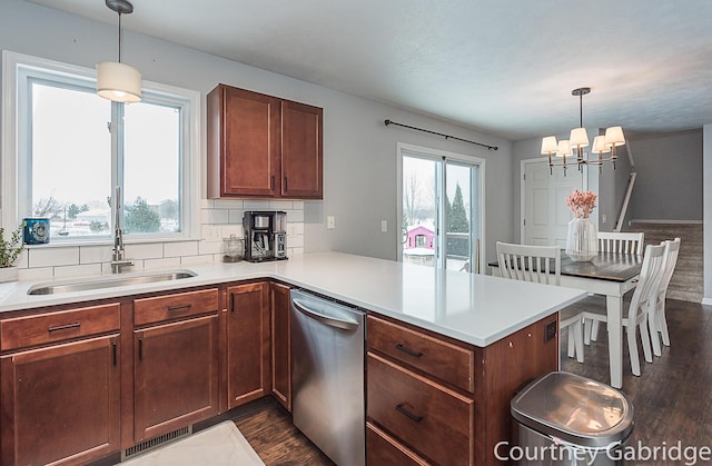 kitchen featuring stainless steel dishwasher, decorative light fixtures, kitchen peninsula, and a chandelier