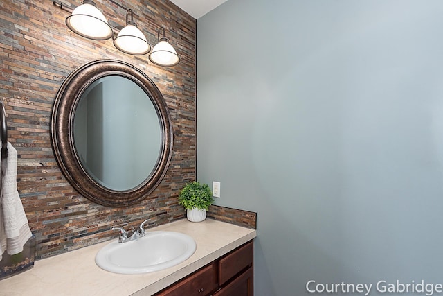 bathroom with tasteful backsplash and vanity