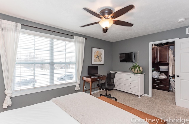 carpeted bedroom with ceiling fan and a closet