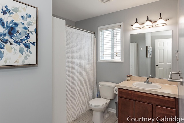 bathroom featuring vanity and toilet