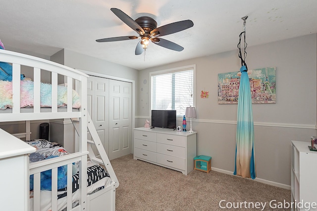 bedroom featuring ceiling fan, a closet, and light colored carpet