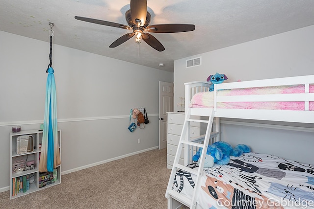 bedroom with carpet flooring, a textured ceiling, and ceiling fan