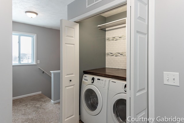 laundry room with light colored carpet and washing machine and clothes dryer