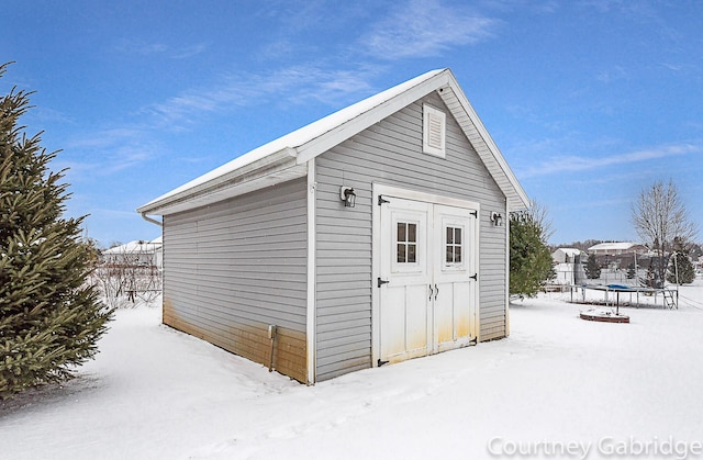 snow covered structure with a trampoline