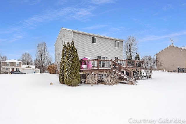 snow covered house with a deck