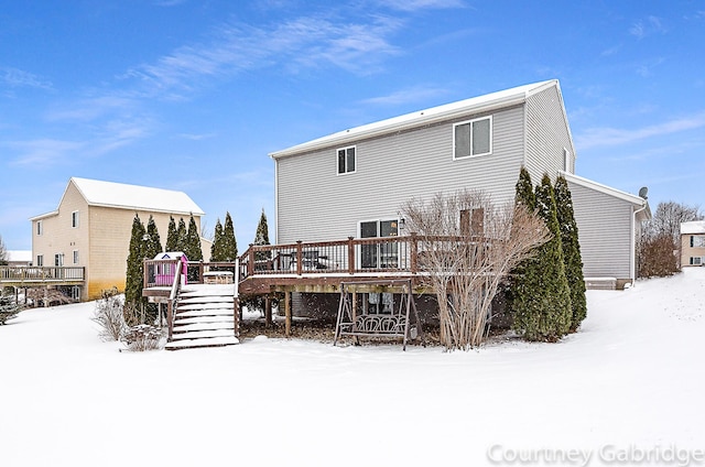 snow covered property featuring a wooden deck