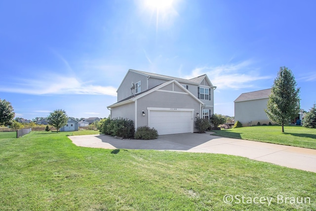 view of side of home featuring a lawn and a garage