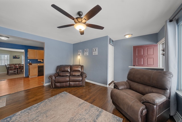 living room with ceiling fan and dark hardwood / wood-style floors