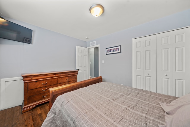 bedroom featuring a closet and dark hardwood / wood-style floors