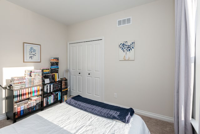 carpeted bedroom with a closet