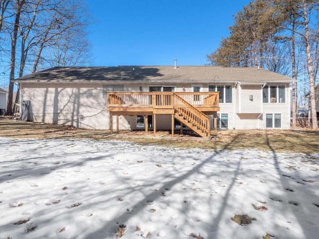 snow covered property with a deck