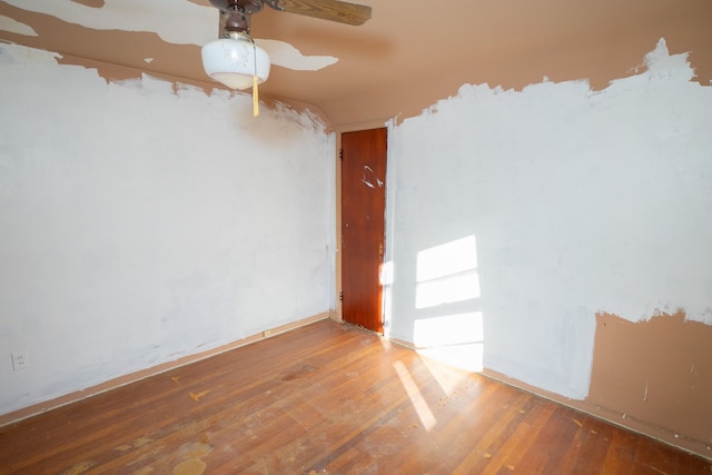 spare room with wood-type flooring and ceiling fan