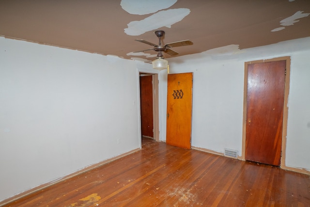 spare room with ceiling fan and dark hardwood / wood-style floors