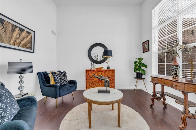 sitting room with dark hardwood / wood-style flooring