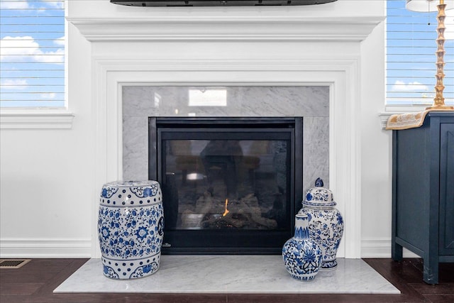 details with hardwood / wood-style floors and a fireplace