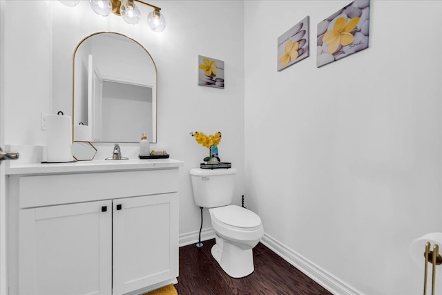 bathroom featuring hardwood / wood-style floors, toilet, and vanity