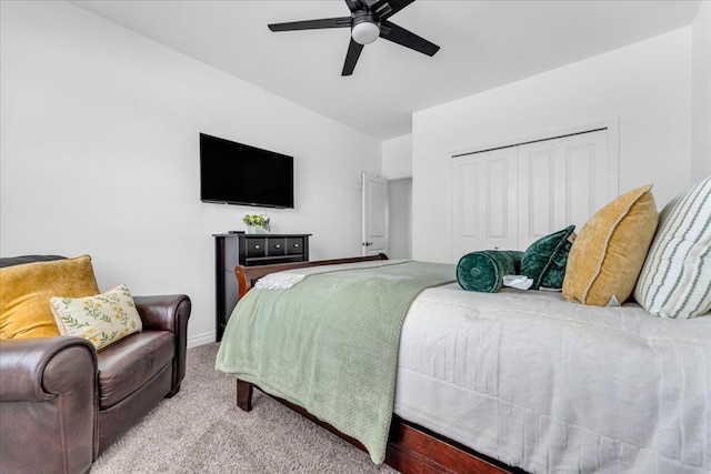 bedroom with ceiling fan, a closet, and light carpet