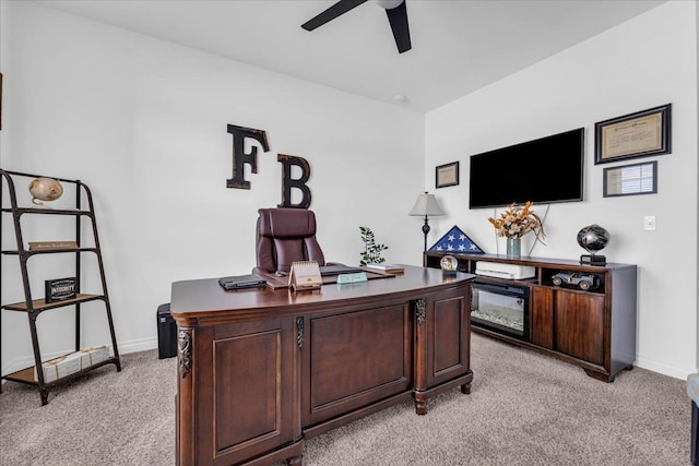 home office with light carpet and ceiling fan