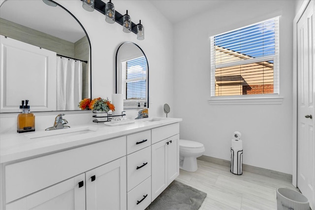 bathroom featuring toilet, a shower with curtain, and vanity