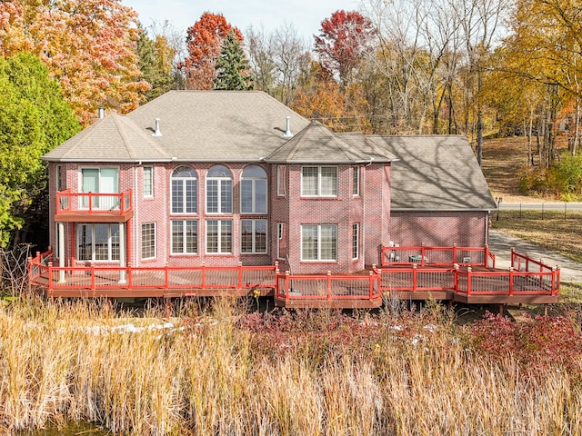 rear view of house featuring a balcony