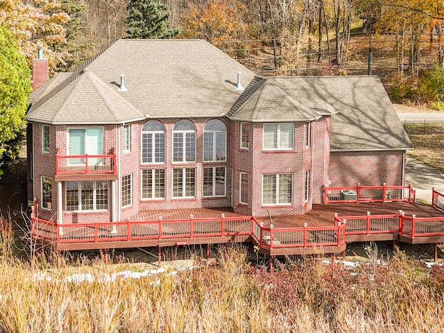 rear view of house with a balcony and a deck