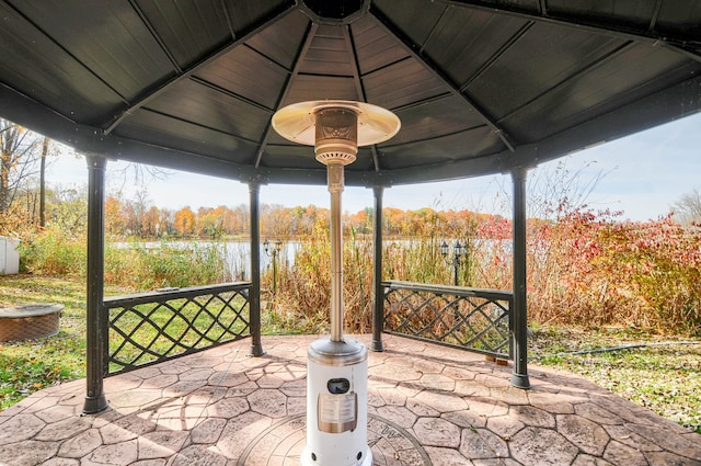 view of patio featuring a gazebo and a water view