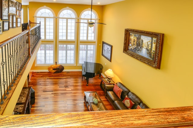 living room featuring hardwood / wood-style flooring, ceiling fan, and a healthy amount of sunlight