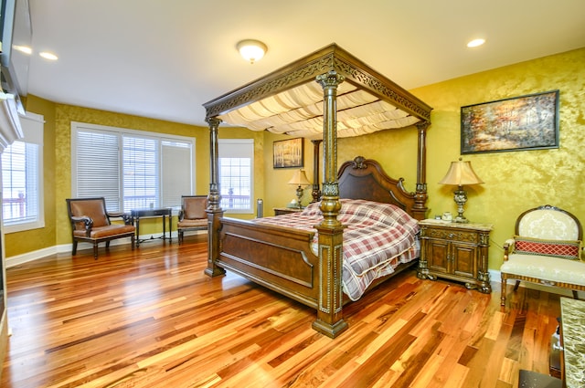 bedroom featuring multiple windows and hardwood / wood-style flooring